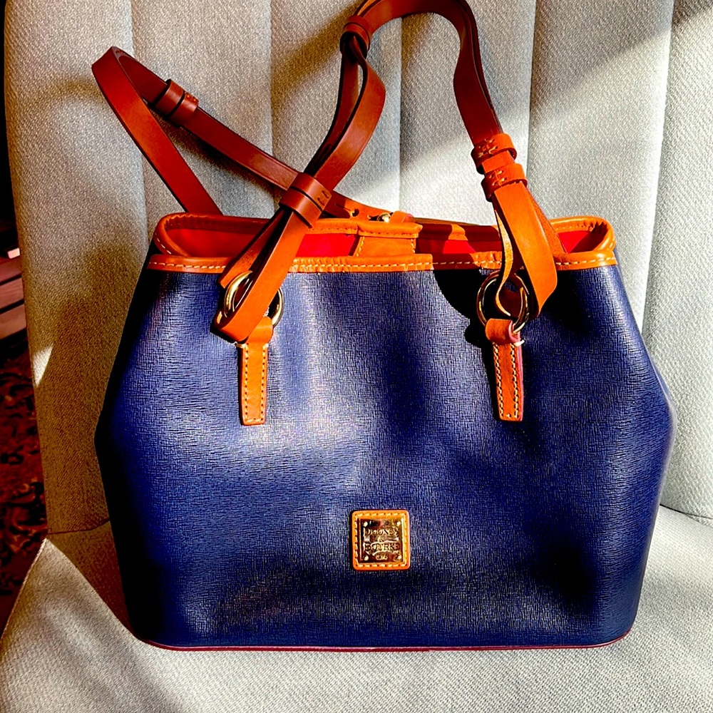 Dooney & Bourke purse. Navy with red interior lining .